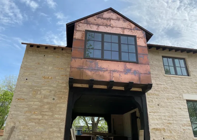 Copper metal panel facade on a stone building for Skylight Installation in Aquia Harbour